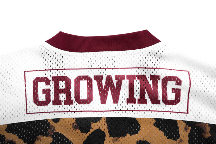 Close-up of the jersey back showing burgundy-outlined Growing text on a white mesh shoulder panel