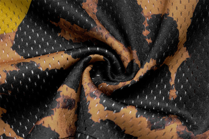 Close-up of the jersey's brown and black leopard print mesh fabric showing its textured perforated surface