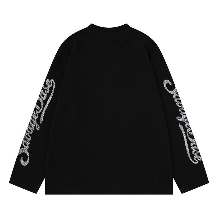Back view of a black waffle knit long sleeve shirt with white script graphics along both sleeves