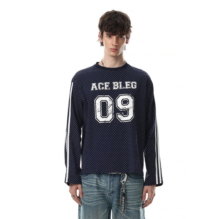 Navy long-sleeve tee worn on a model with a dotted pattern, striped sleeves, ACE BLEG text, and number 09