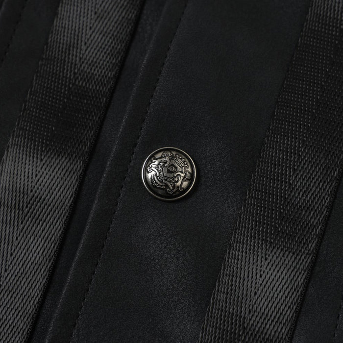 Black jacket front button detail with textured tape trim on either side