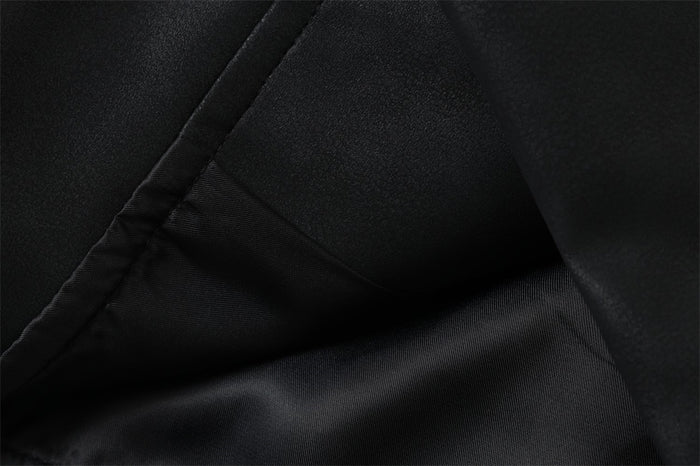 Black jacket interior close-up showing lining and stitched seam details