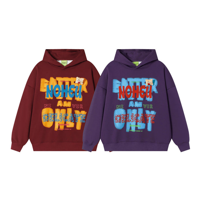 Two oversized graphic pullover hoodies in burgundy and purple with bold multicolor lettering and bear patches