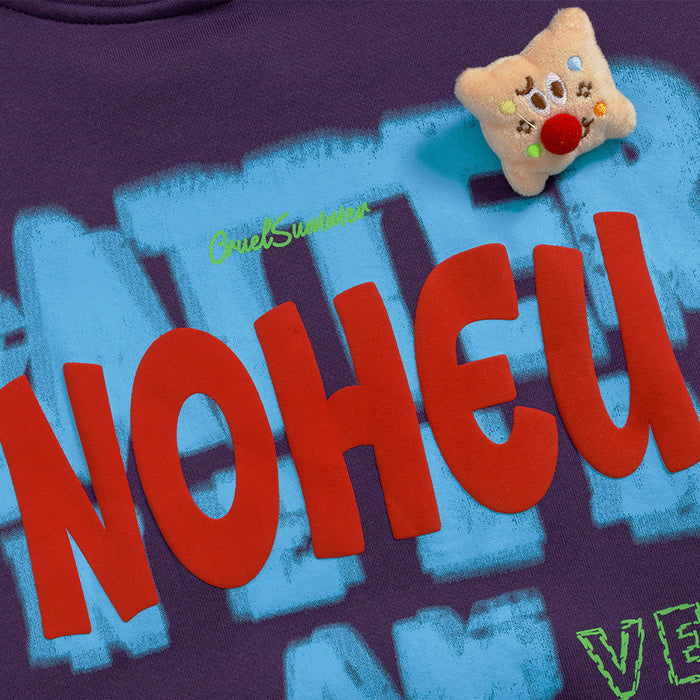 Close-up of the purple hoodie graphic showing large red lettering over blue brushstroke shapes and a bear patch