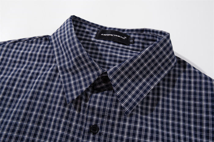 Navy plaid shirt collar and top button close-up