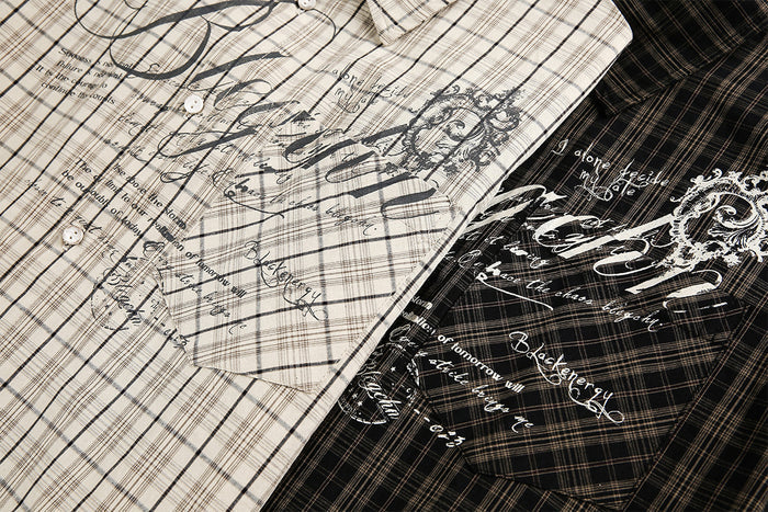 Close-up of beige and black plaid shirt fronts featuring contrasting vintage script and decorative graphics