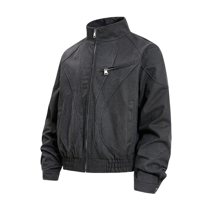 Black bomber jacket in angled front view showing the raised collar, curved seams, zippered chest pocket, and cuffs