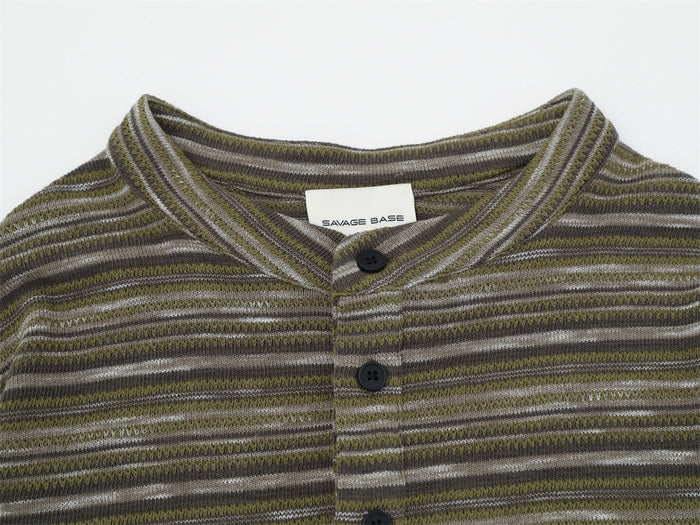 Close-up of the olive striped henley collar, neck label, and black buttons