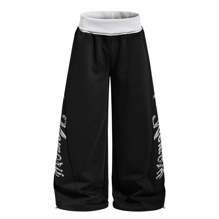 Black wide-leg sweatpants shown from the front with a contrasting white ribbed waistband and side lettering