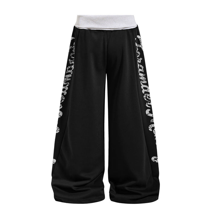 Black wide-leg sweatpants showing the reverse side with large distressed white lettering along both outer legs