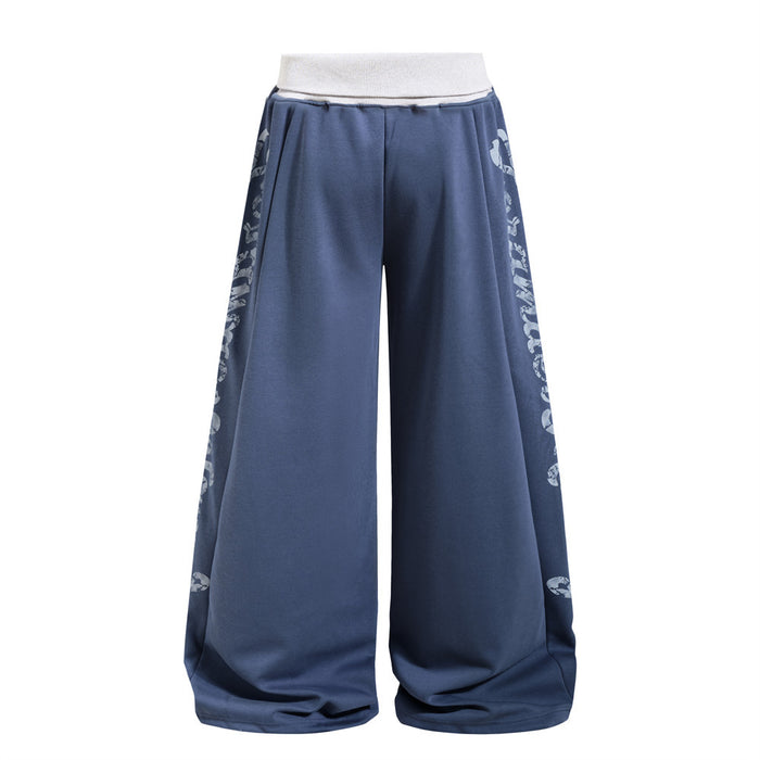 Slate blue wide-leg sweatpants showing the reverse side with distressed white lettering along both outer legs