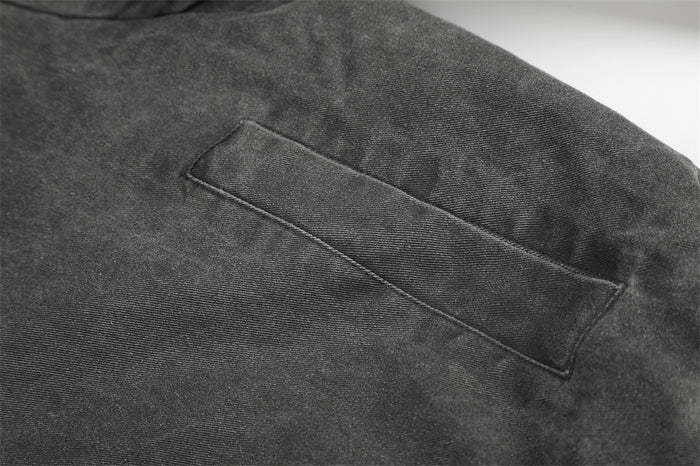 Close-up of welt pocket on charcoal workwear jacket