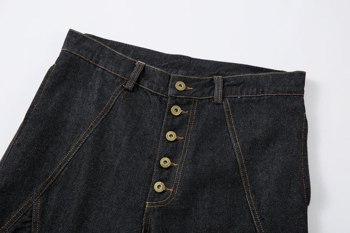 Upper front of dark denim pants showing waistband and five-button fly