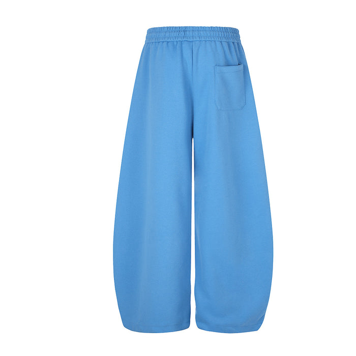 Blue wide-leg sweatpants shown from the back with an elastic waistband and stitched rear pocket