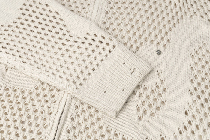 Cream openwork knit sleeve cuff showing ribbed edging and varied perforated stitch patterns