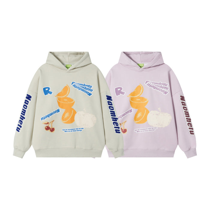 Two oversized graphic hoodies in cream and lilac with orange fruit, cherry, and letter prints