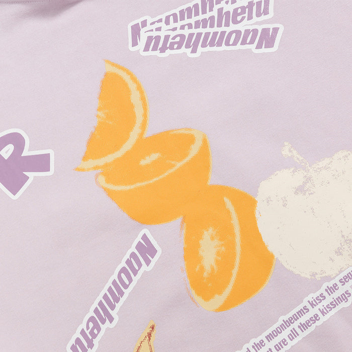 Close-up of the lilac hoodie graphic featuring orange citrus slices, white fruit, and purple lettering