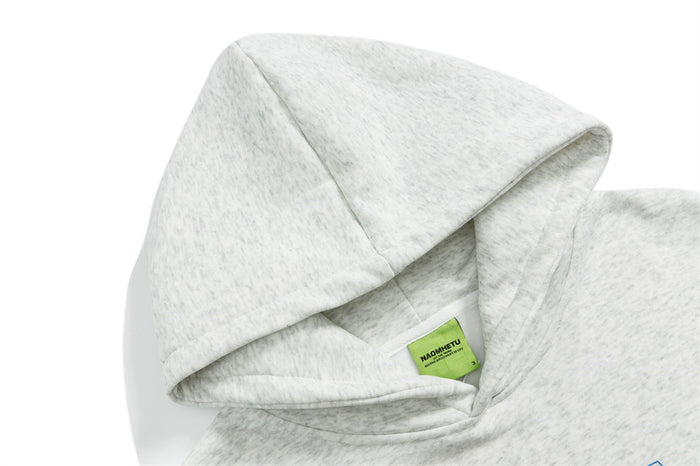 Close-up of the light gray hoodie hood and inner neckline with a small green fabric tag