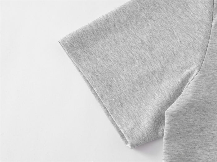 Close-up of light gray T-shirt sleeve and side seam