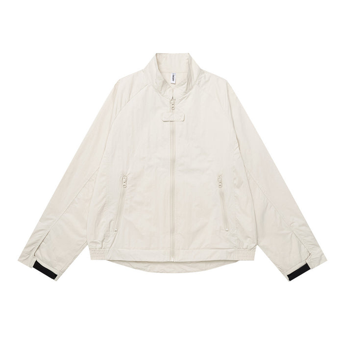 Men's oversized cream stand-collar zip-up jacket with zip pockets and contrast black cuffs, front view