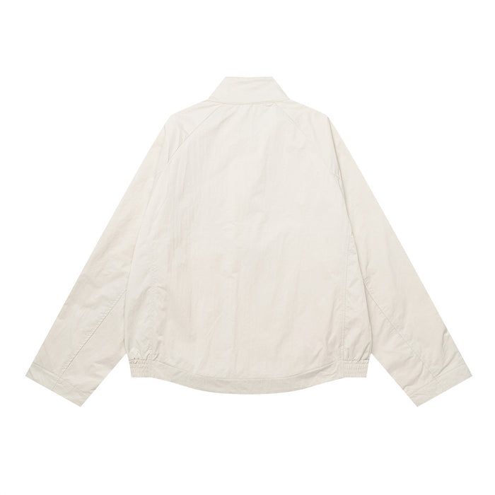 Back view of an oversized cream stand-collar jacket with long sleeves and an elasticized hem