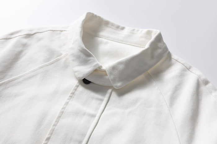 Close-up of white bomber jacket collar and top button placket