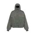 Oversized patchwork hooded bomber jacket with frayed seams in washed grey canvas, front view