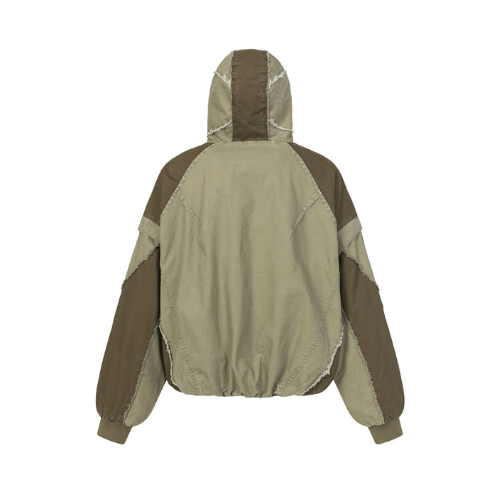 Olive and brown patchwork hooded bomber jacket shown from the back with a gathered hem