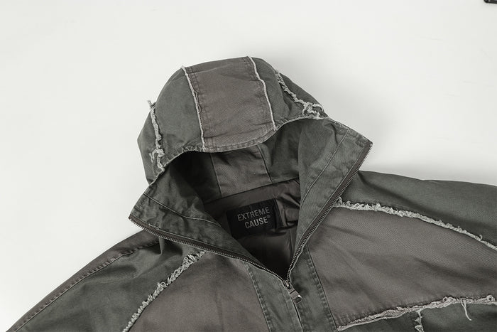 Charcoal gray jacket hood opened to reveal the inner collar, lining, and sewn neck label