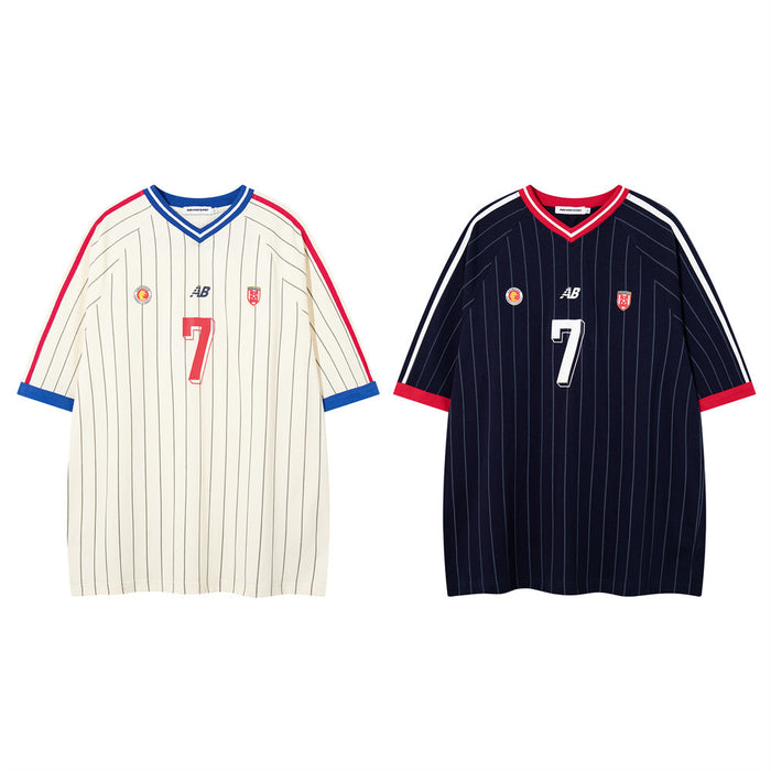Oversized pinstripe soccer jersey tee with number 7 graphic and contrast V-neck trim in cream and navy colorways