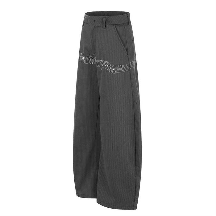 Side view of gray pinstripe wide-leg trousers with white music note embroidery