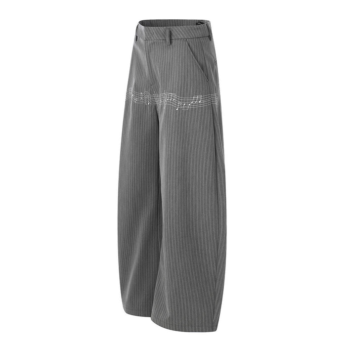 Angled side view of gray pinstripe wide-leg trousers with music note embroidery