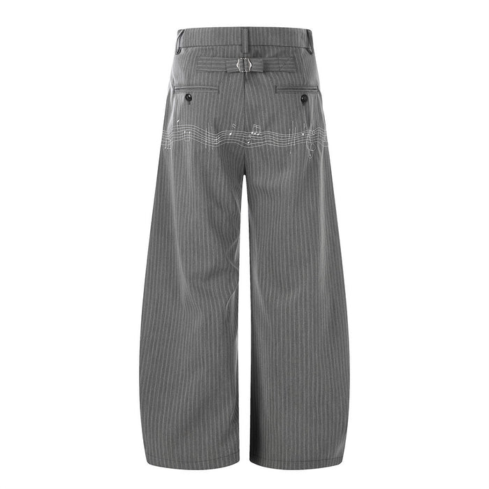 Back view of gray pinstripe wide-leg trousers with belt detail and music note embroidery
