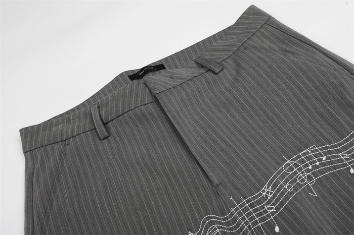 Close-up of gray pinstripe trousers at the waistband and front fly