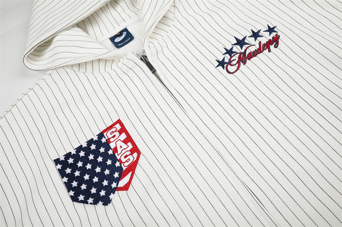 Close-up of the white pinstriped hoodie front showing the flag patch and embroidered star script