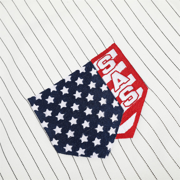 Close-up of a navy star-patterned flag patch with red and white lettering on white pinstriped fabric