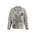 Beige ribbed knit sweater with plaid collar, layered sleeves, and bear graphic front view