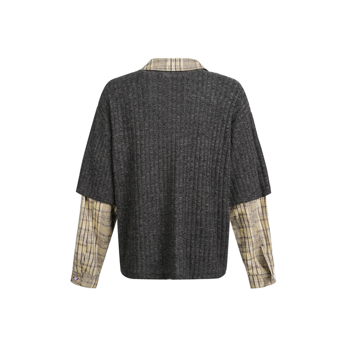 Back view of black ribbed knit sweater with plaid sleeve cuffs and collar