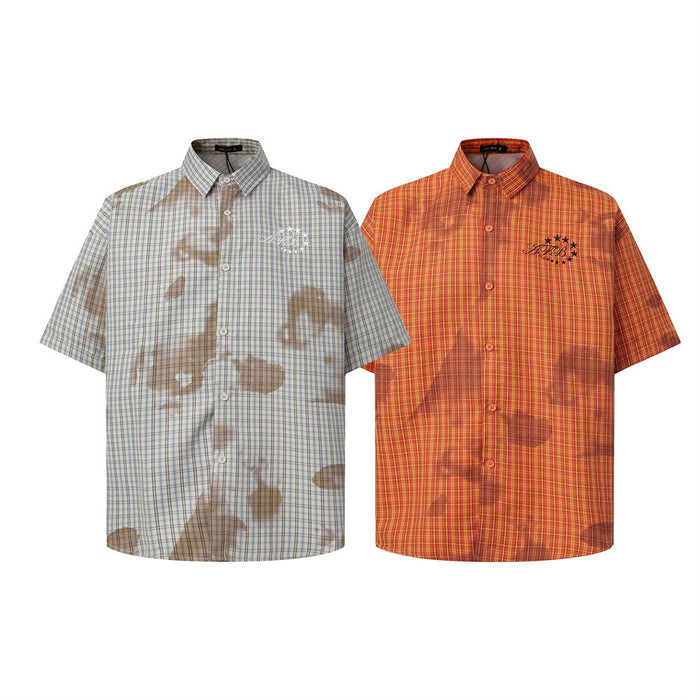 Two plaid short-sleeve button-up shirts in beige-blue and orange-red tie-dye wash