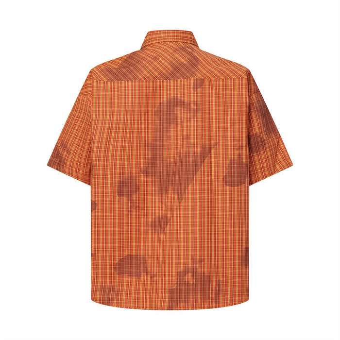 Back view of orange-red plaid short-sleeve shirt with washed tie-dye patches