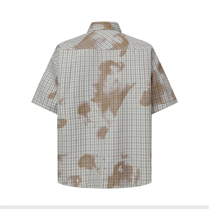 Back view of beige-blue plaid short-sleeve shirt with large washed tie-dye patches