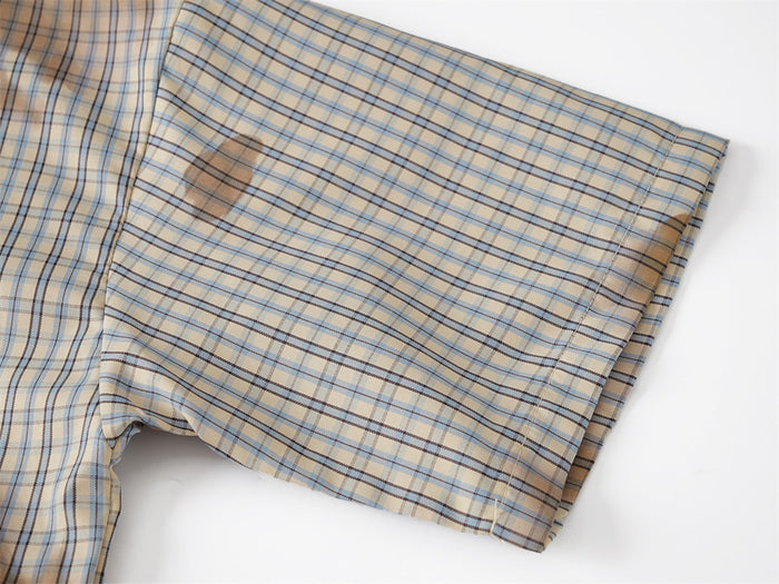 Close-up of plaid short sleeve with beige and blue check pattern