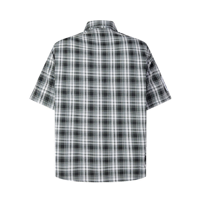 Back view of black-and-white plaid short-sleeve shirt with white sleeve number patch
