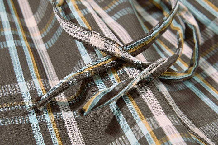 Close-up of plaid drawstring ties on the pants waistband