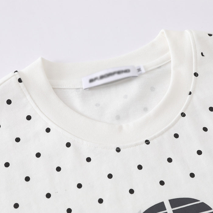 Close-up of white crew neck collar and black polka dot print on the T-shirt