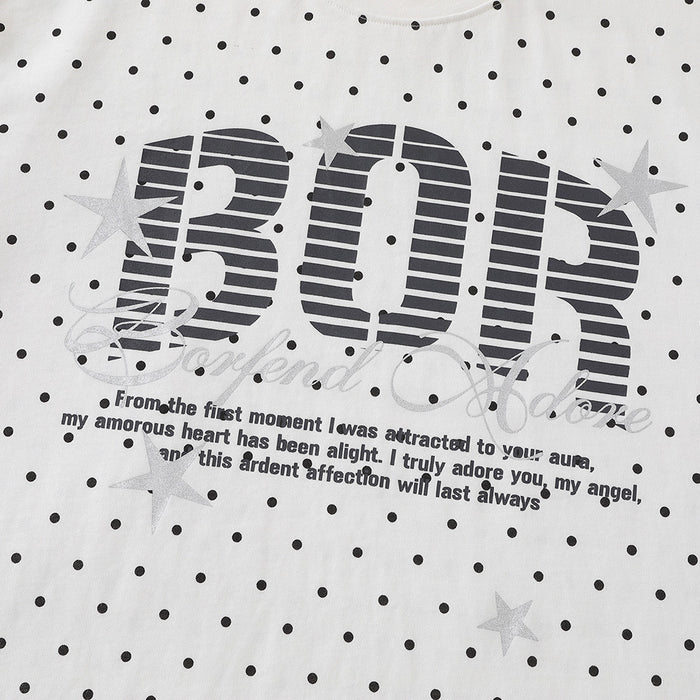 Close-up of BOR front graphic with stars and text on white polka dot T-shirt