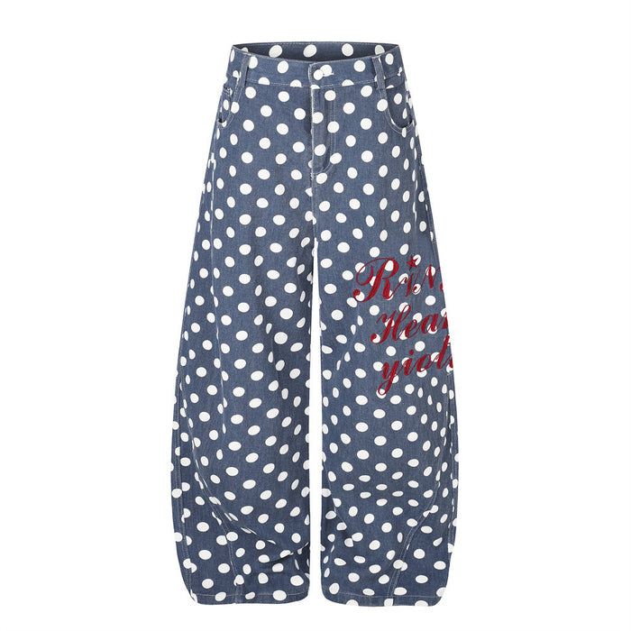 Front view of blue wide-leg pants with white polka dots, curved hems, pockets, and red script graphic