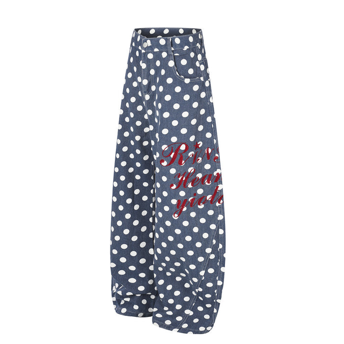 Angled front view of blue polka dot wide-leg pants with front pockets and curved hems