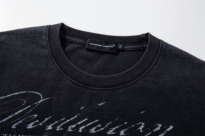 Close-up of the crew neck and printed chest graphic on a washed black long sleeve T-shirt