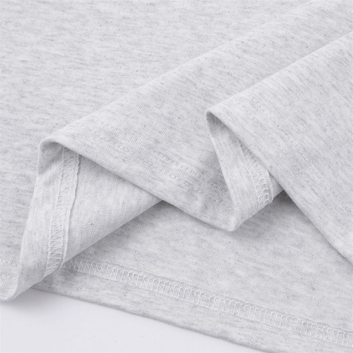Close-up of the light gray knit fabric, folded sleeve edge, and stitched hem finish